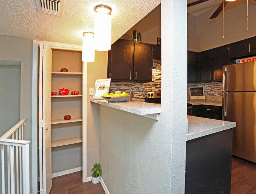Brownstone Townhomes kitchen area, breakfast bar, shelving, and with decor