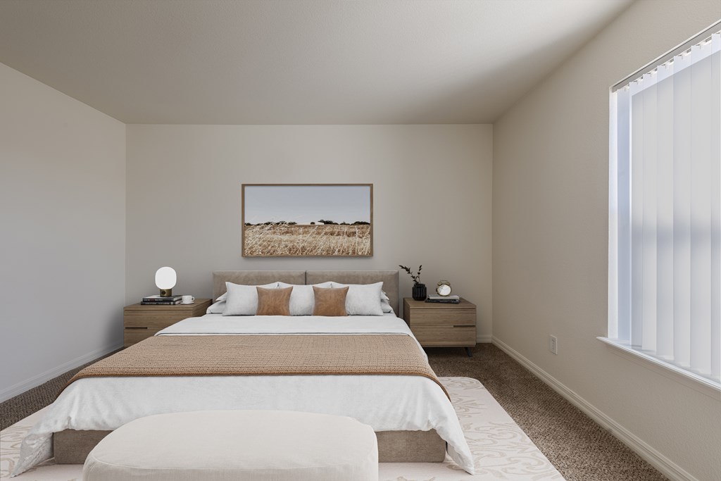 A bedroom with a large bed and a painting on the wall.