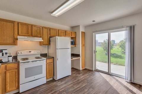 A kitchen with wooden cabinets and a white refrigerator.