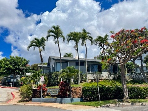 a building with palm trees in front of it