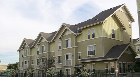 a large house with a fence in front of it