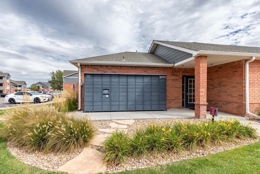 A red brick house with a black garage door.