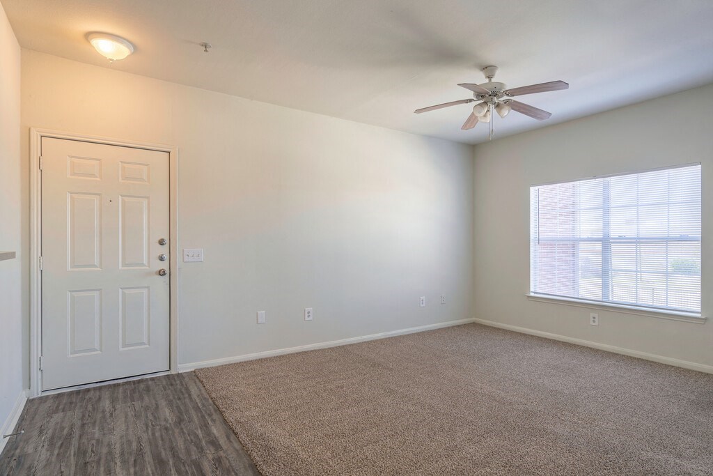 a bedroom with a ceiling fan and a window