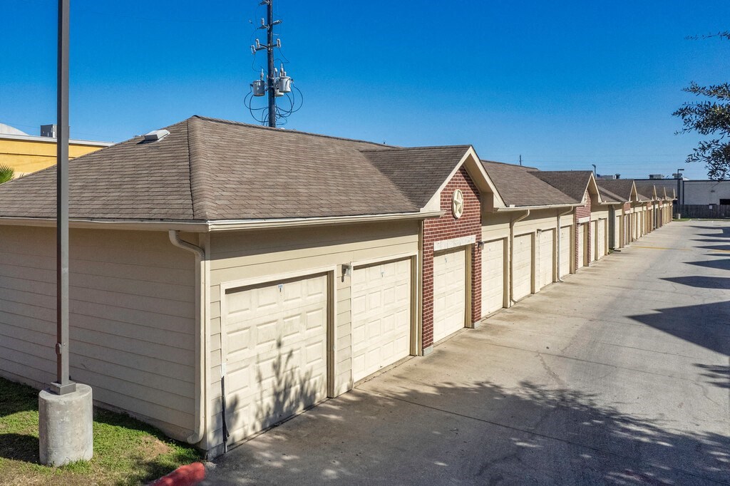 a row of garages in a row with a blue sky in the background