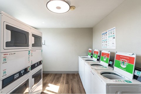 a kitchen with a microwave and a washer and dryer