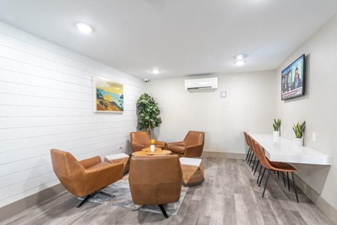 a living room with couches and a table and chairs