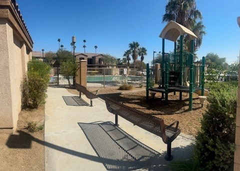 A playground with a slide and a swing set.