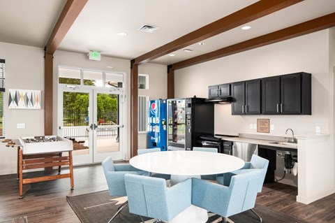 A modern kitchen with a dining table and chairs.