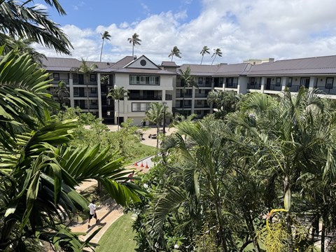 A view of a resort with a person walking on the grass.
