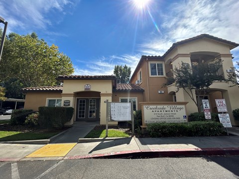 A sunny day at Creekside Village Apartments with a clear blue sky.