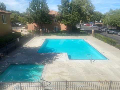 A small pool with a fence around it.
