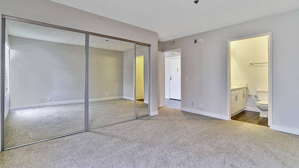 Indie Westside unfurnished bedroom with mirror closet