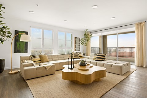 A modern living room with a large sectional sofa and a coffee table.