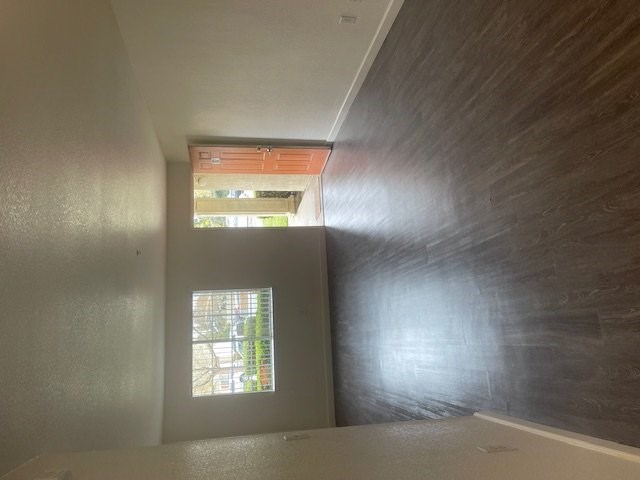 A room with a window and a view of a street.