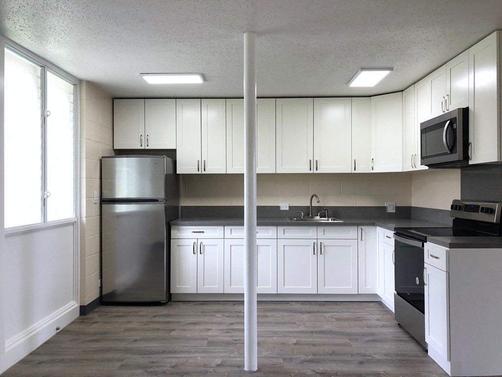Hale Makiki Apartments kitchen area with appliances and cabinets