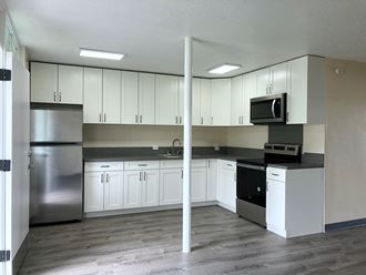 Hale Makiki Apartments kitchen area with appliances and cabinets