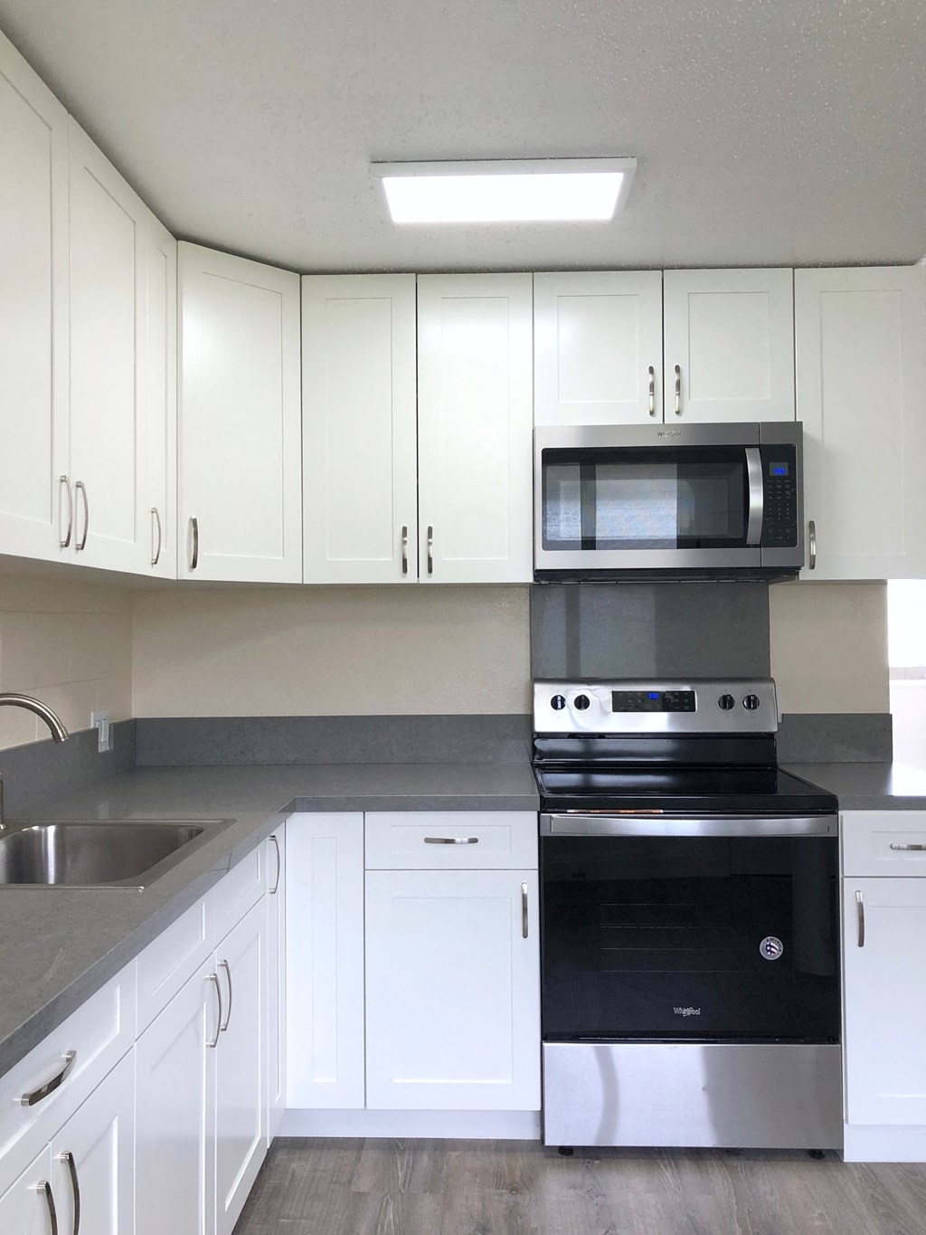 Hale Makiki Apartments kitchen area with appliances and cabinets