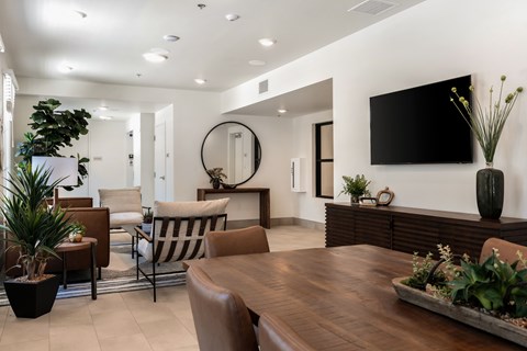A modern living room with a wooden table and chairs.