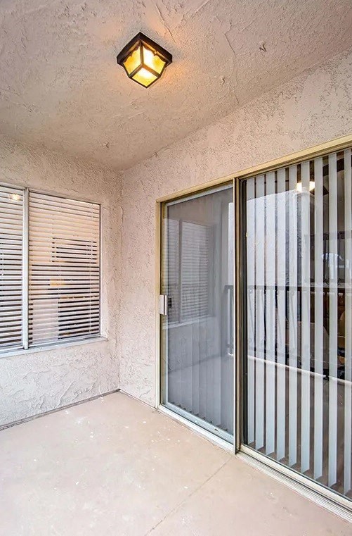 a patio with a sliding glass door and a window
