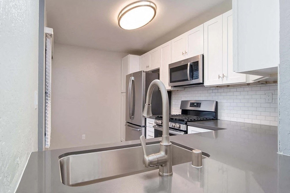 a kitchen with a sink and a microwave