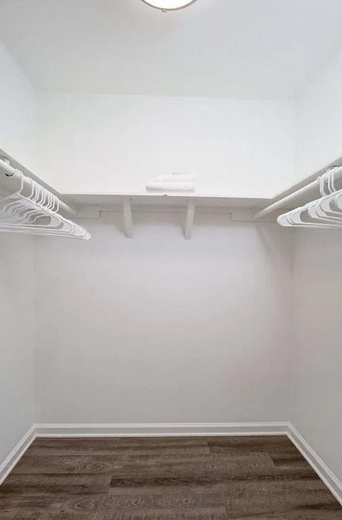 Indie Fairview  closet with white walls and a white shelf on the wall