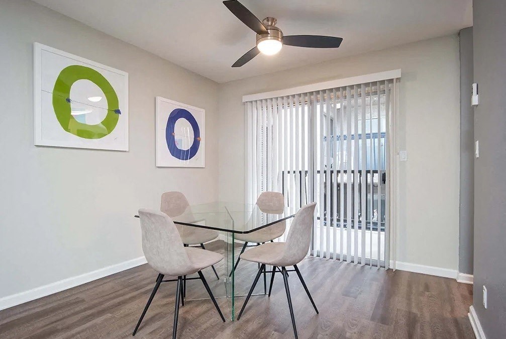 a dining room with a glass table and chairs