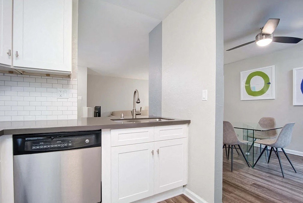 a kitchen with a bunch of people silhouettes on a wall
