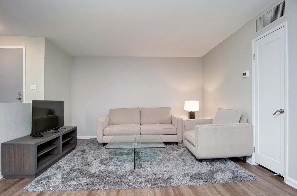 a living room with a couch and a tv