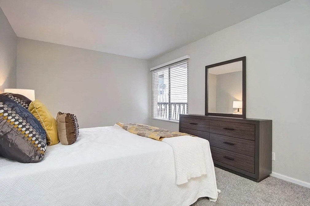 a bedroom with a bed and a dresser