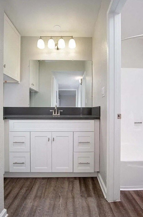 a white bathroom with a sink and a mirror