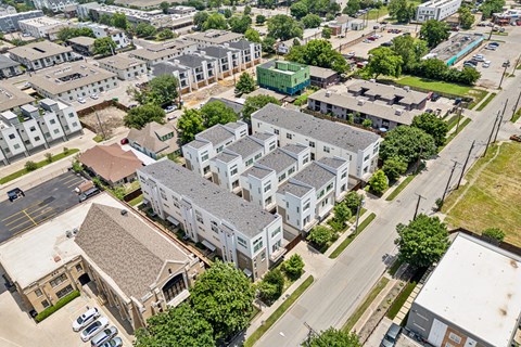 A large building complex with a parking lot in front.