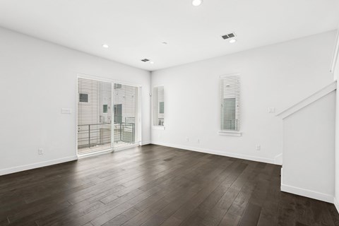 A room with wooden floors and white walls.