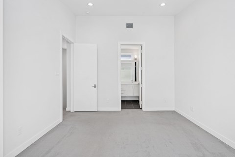 A white room with a door and a window.