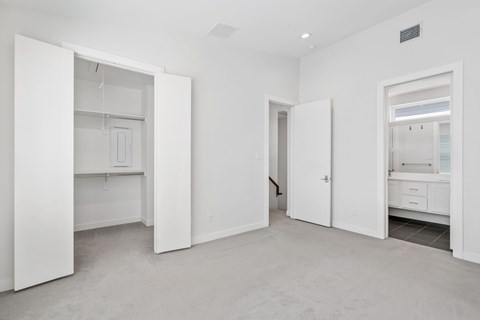 A white room with a doorway leading to another room.