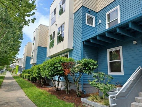 a blue and white building with a sidewalk in front of it