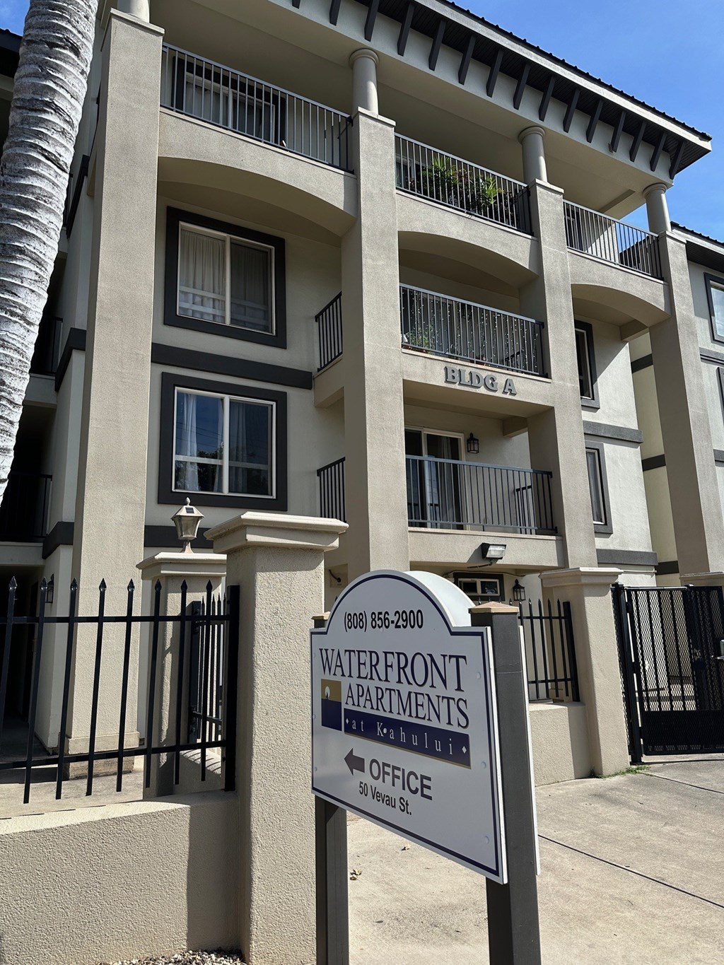 A sign for the Waterfront Apartments is in front of a building.