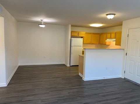 A kitchen area with wooden cabinets and a white countertop.