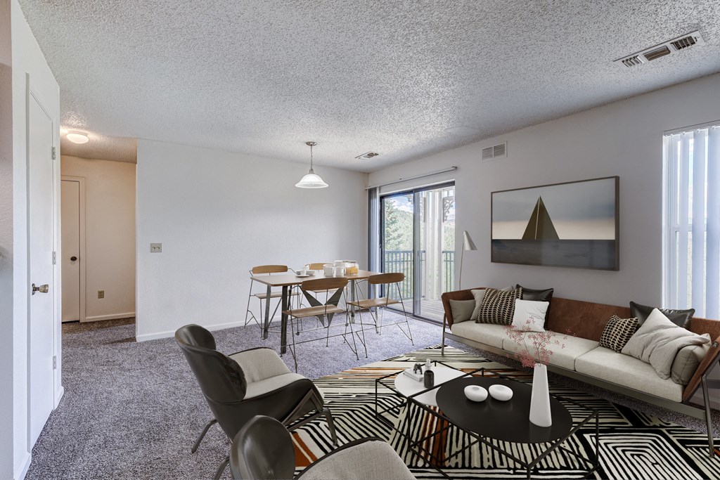 A living room with a sofa, chairs, and a coffee table.