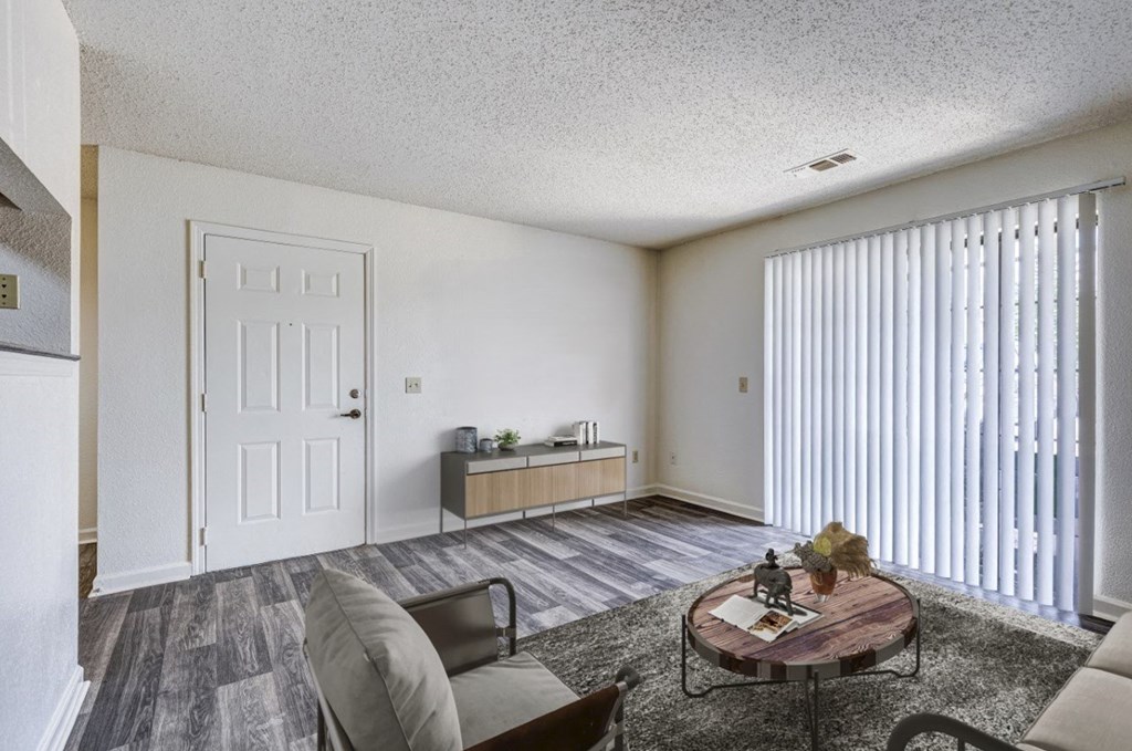 A living room with a grey couch and a coffee table.