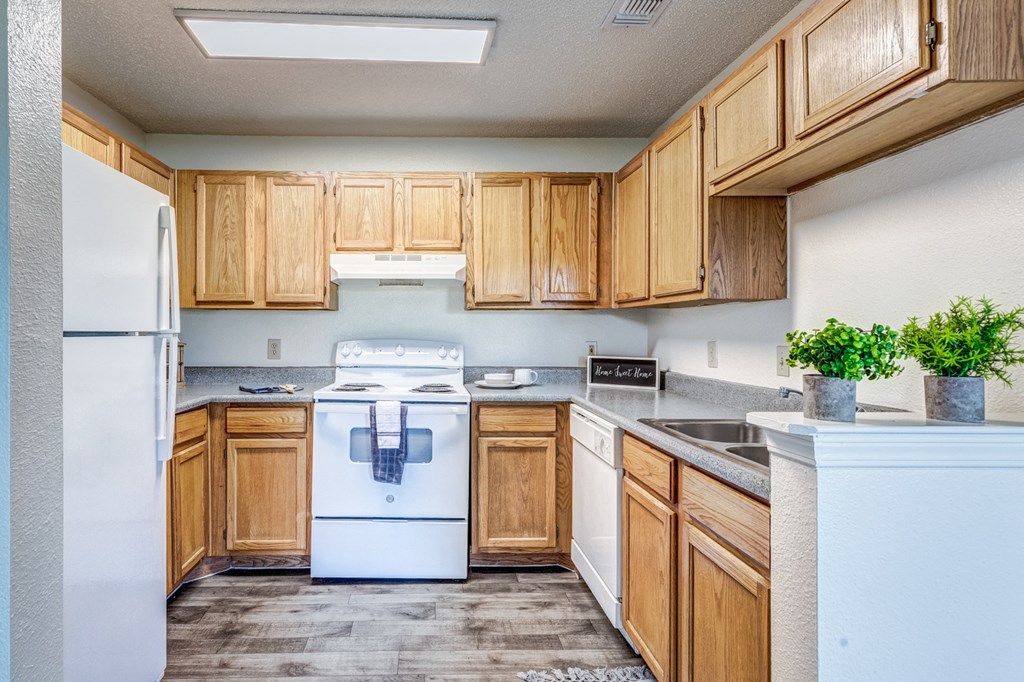 A kitchen with wooden cabinets and a white refrigerator.