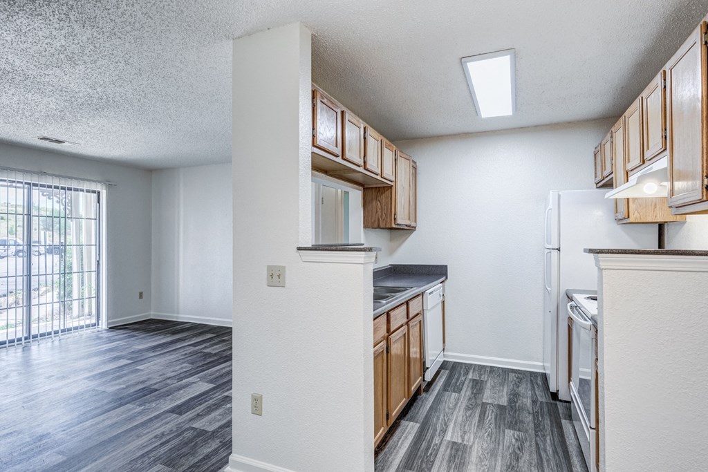 A kitchen with white cabinets and a refrigerator.