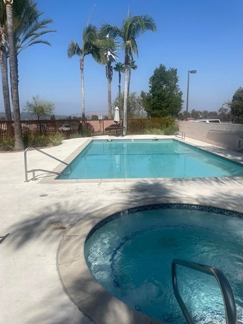 A pool surrounded by palm trees.