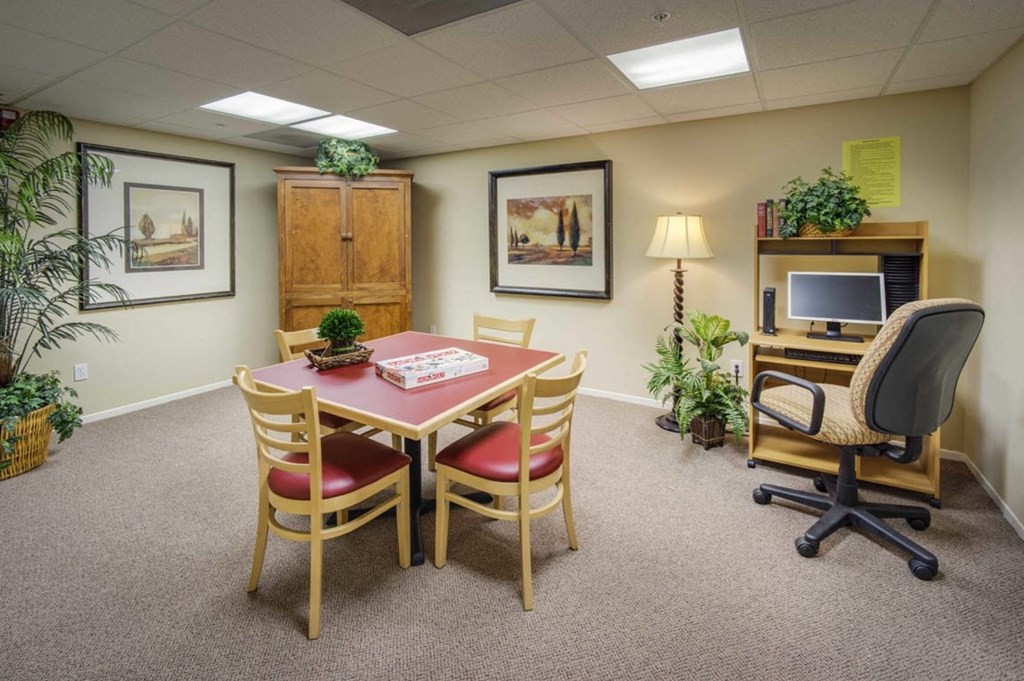 a dining room with a table and chairs and a television