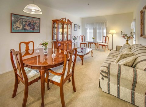 a living room with a dining table and a couch