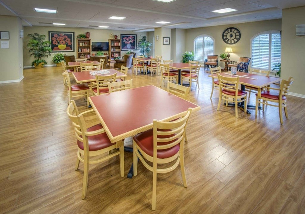 a large dining room with tables and chairs