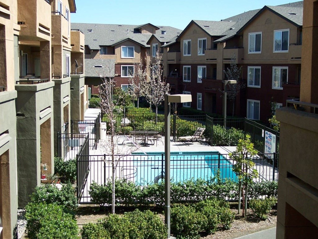 an apartment building with a pool in the middle
