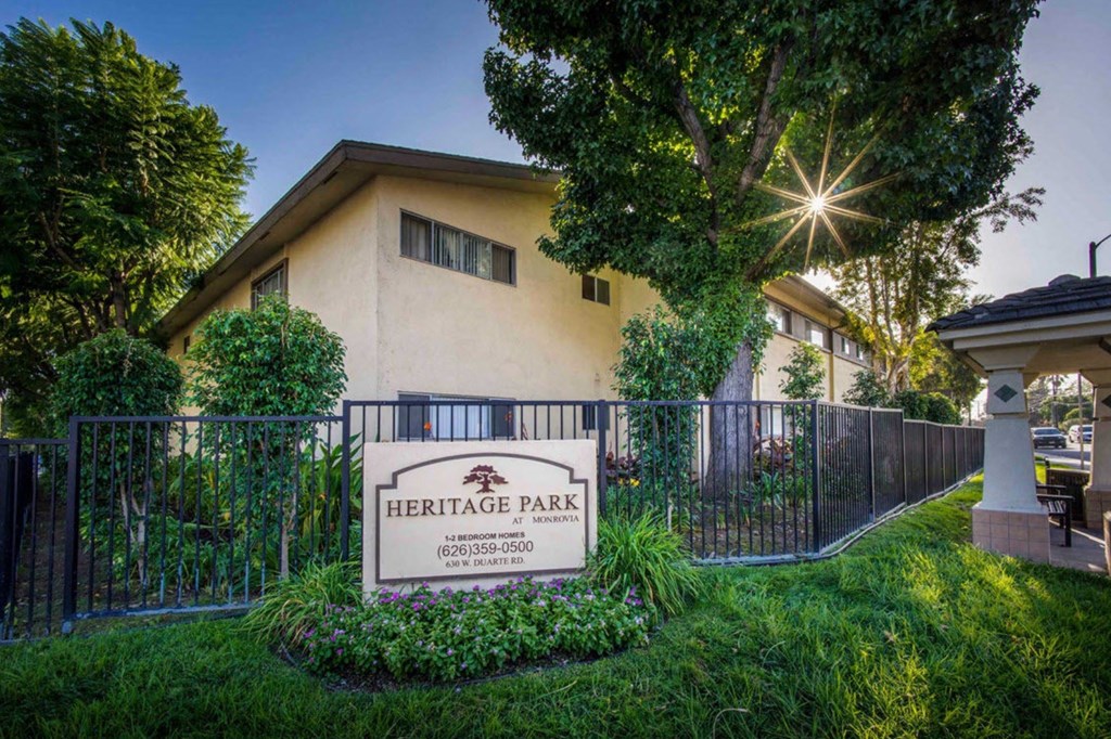 a home with a fence and a sign for heritage park