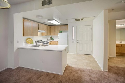 a kitchen and living room with a white counter top