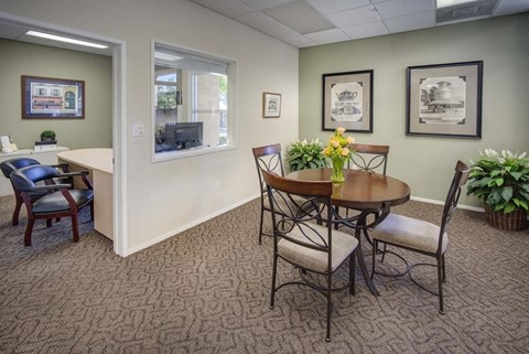 a dining room with a table and chairs