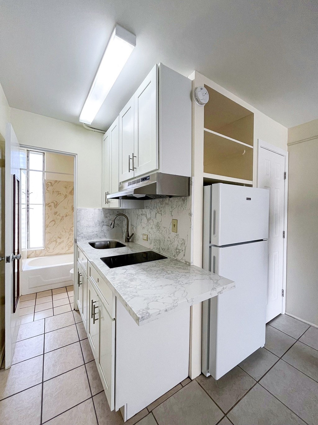 Kitchen a kitchen with white cabinets and a white refrigerator